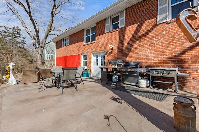 view of patio featuring outdoor dining area and a grill