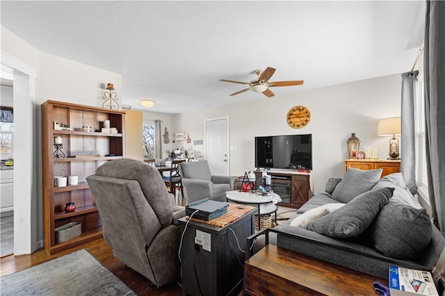 living room featuring a ceiling fan and wood finished floors