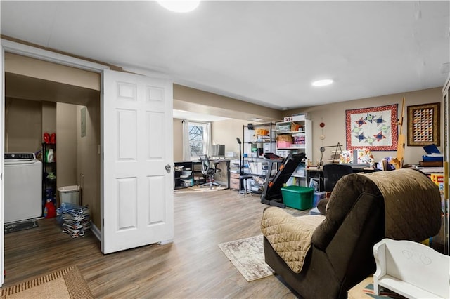 living area featuring washer / dryer and wood finished floors