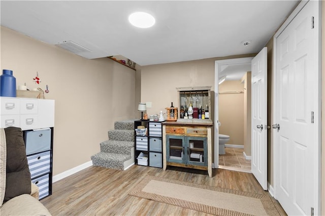 office area featuring visible vents, baseboards, and wood finished floors