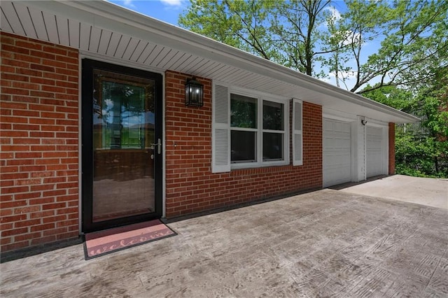 904 E Golf Hill Dr, Excelsior Springs, MO 64024 - doorway to property with brick siding, concrete driveway, and an attached garage