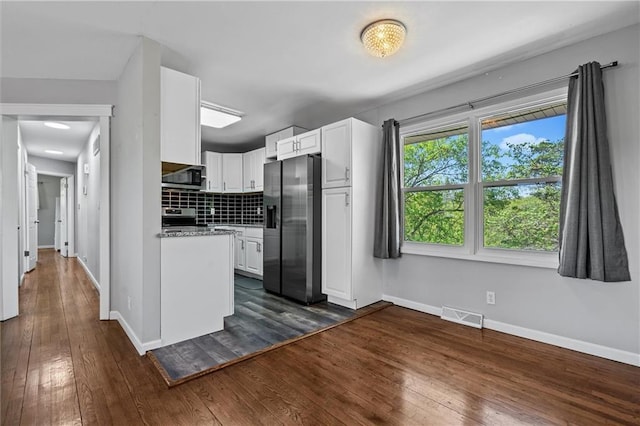 904 E Golf Hill Dr, Excelsior Springs, MO 64024 - kitchen with appliances with stainless steel finishes, white cabinetry, baseboards, dark wood finished floors, and backsplash