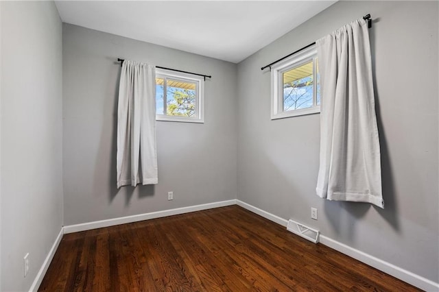 904 E Golf Hill Dr, Excelsior Springs, MO 64024 - spare room featuring plenty of natural light, dark wood-style flooring, and baseboards