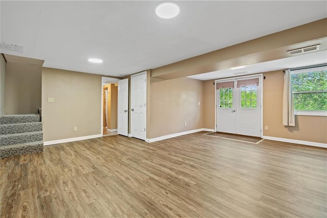 904 E Golf Hill Dr, Excelsior Springs, MO 64024 - unfurnished living room with wood finished floors, baseboards, and stairs