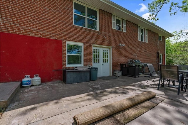 904 E Golf Hill Dr, Excelsior Springs, MO 64024 - rear view of house with a patio, outdoor dining space, and brick siding