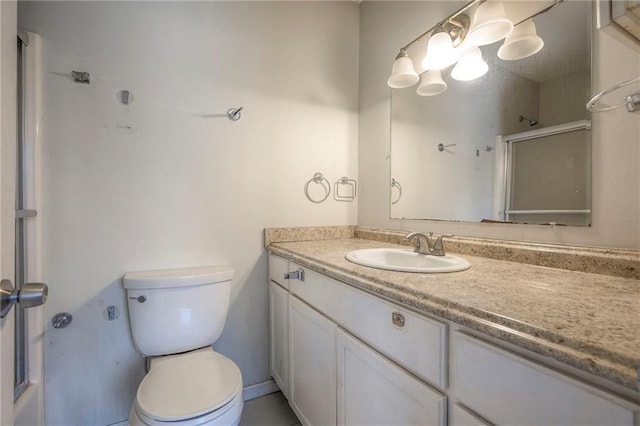 full bathroom with toilet, an enclosed shower, and vanity