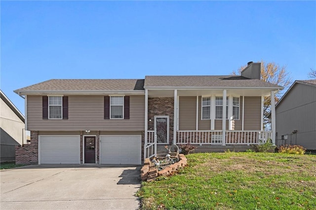 split foyer home with a chimney, a front lawn, a porch, and brick siding