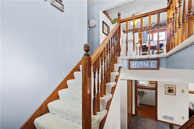 stairs with carpet floors and visible vents