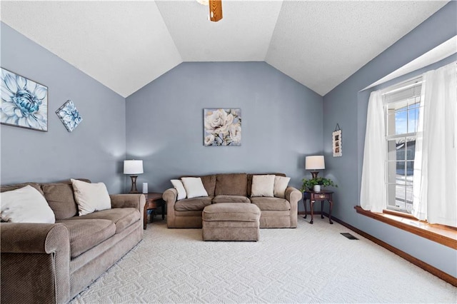 living area featuring baseboards, visible vents, a ceiling fan, light colored carpet, and vaulted ceiling