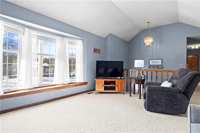 living room featuring carpet floors, lofted ceiling, visible vents, a chandelier, and baseboards