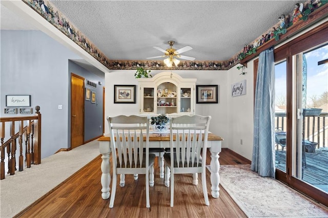 dining area featuring a textured ceiling, wood finished floors, and a ceiling fan