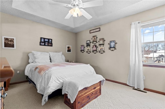 bedroom featuring light carpet, a textured ceiling, visible vents, and baseboards