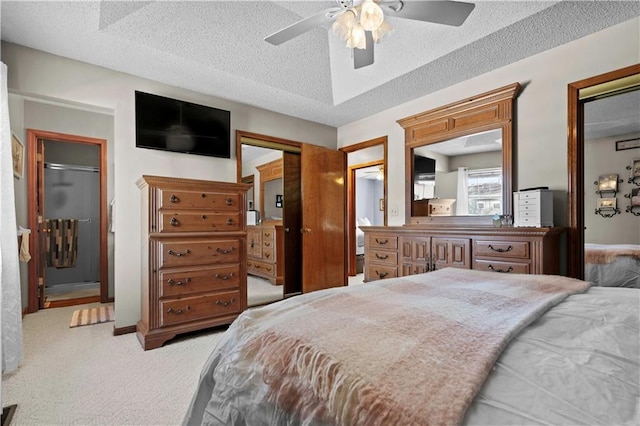 bedroom with a textured ceiling, ceiling fan, carpet flooring, and baseboards