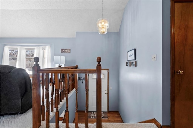 stairway with an inviting chandelier