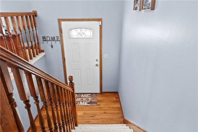 entrance foyer with stairway and wood finished floors