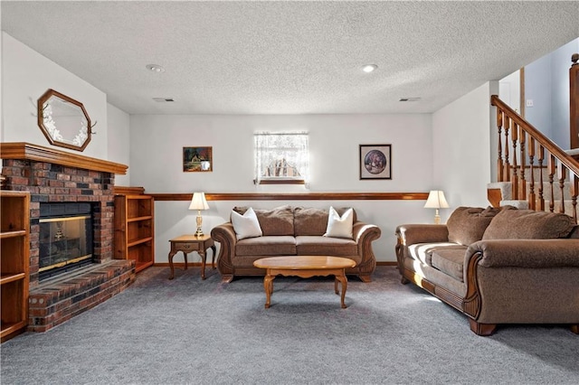 living area featuring visible vents, baseboards, carpet, a textured ceiling, and a brick fireplace