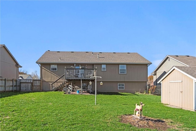 back of property featuring an outbuilding, stairs, a deck, a yard, and a shed