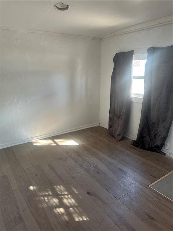 spare room with dark wood-style floors