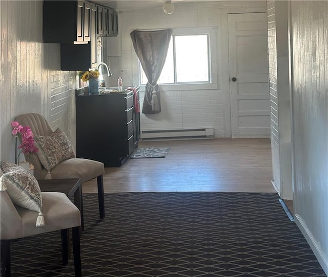 living area featuring baseboard heating and dark wood-type flooring