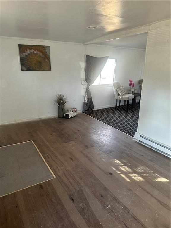 unfurnished room with baseboard heating and dark wood finished floors