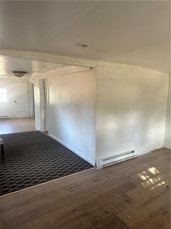 hallway with baseboard heating and dark wood finished floors