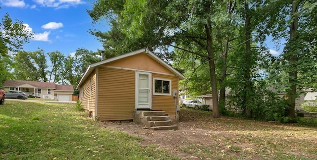 exterior space featuring entry steps and a lawn