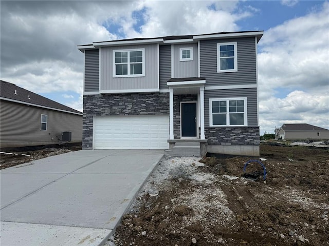 21800 Lucca Ln, Peculiar, MO 64078 - view of front of property featuring stone siding, an attached garage, and driveway