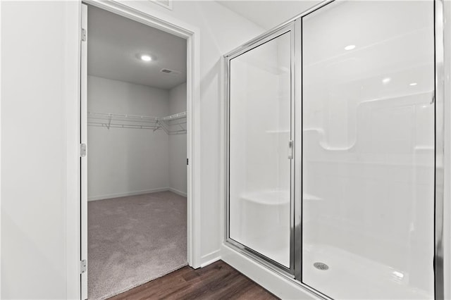 21800 Lucca Ln, Peculiar, MO 64078 - bathroom with a shower stall, a spacious closet, and wood finished floors