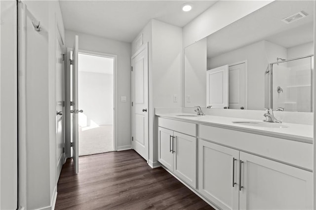 21800 Lucca Ln, Peculiar, MO 64078 - full bath featuring a shower stall, double vanity, wood finished floors, and recessed lighting