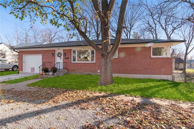 single story home with an attached garage, brick siding, fence, driveway, and a front lawn