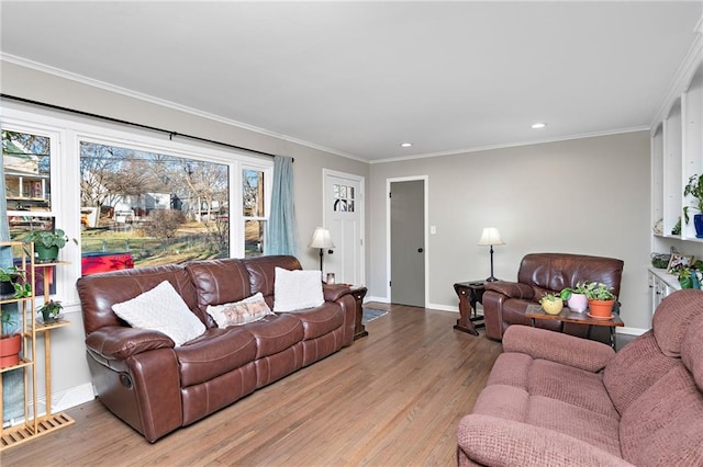 living area with baseboards, visible vents, crown molding, light wood-style floors, and recessed lighting