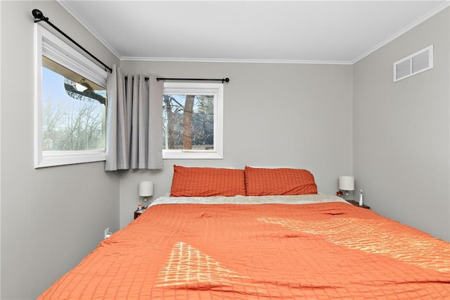 bedroom featuring visible vents and ornamental molding