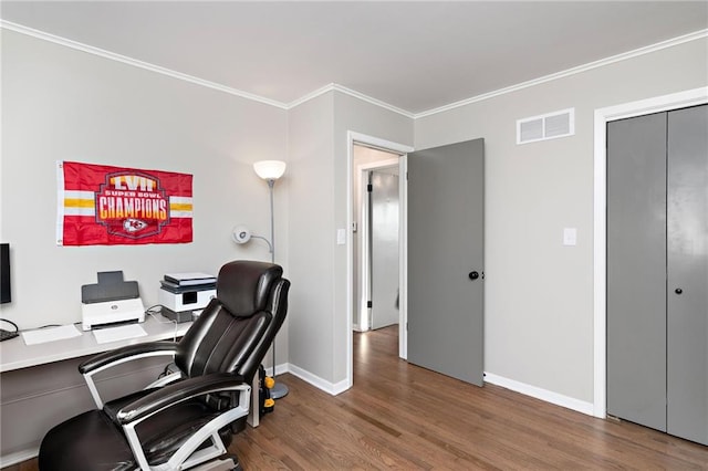 office space featuring ornamental molding, visible vents, baseboards, and wood finished floors