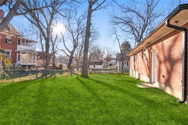 view of yard with a fenced backyard and a residential view