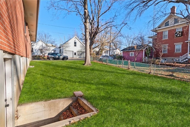 view of yard with a residential view and fence