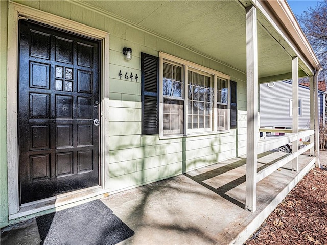 view of exterior entry with covered porch