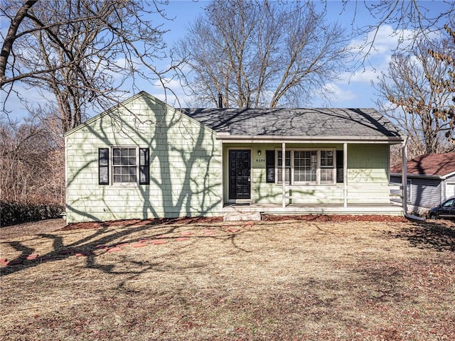 ranch-style home with roof with shingles and covered porch