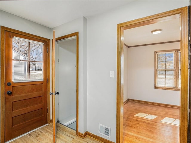 foyer with baseboards, visible vents, a wealth of natural light, and light wood-type flooring