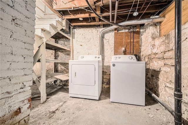 clothes washing area featuring washing machine and dryer and laundry area