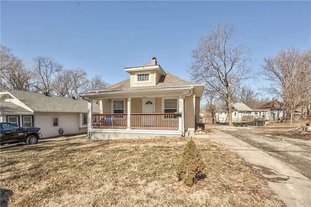 bungalow featuring a porch and a front yard