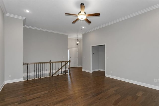 empty room with dark wood-type flooring, recessed lighting, ornamental molding, and baseboards