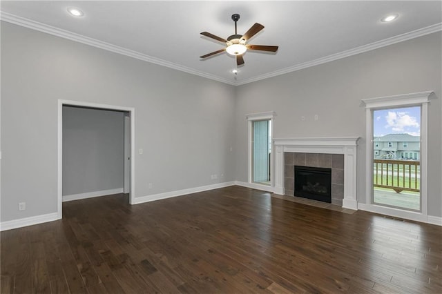 unfurnished living room with dark wood-type flooring, ornamental molding, baseboards, and a ceiling fan