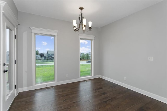 unfurnished dining area with dark wood-style floors, visible vents, a wealth of natural light, and baseboards