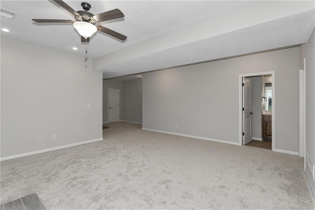 unfurnished room featuring baseboards, visible vents, and light colored carpet