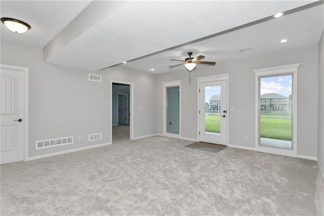 spare room with baseboards, visible vents, and light colored carpet