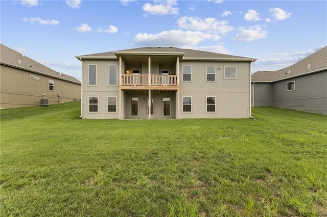 back of property featuring cooling unit, a lawn, and a balcony