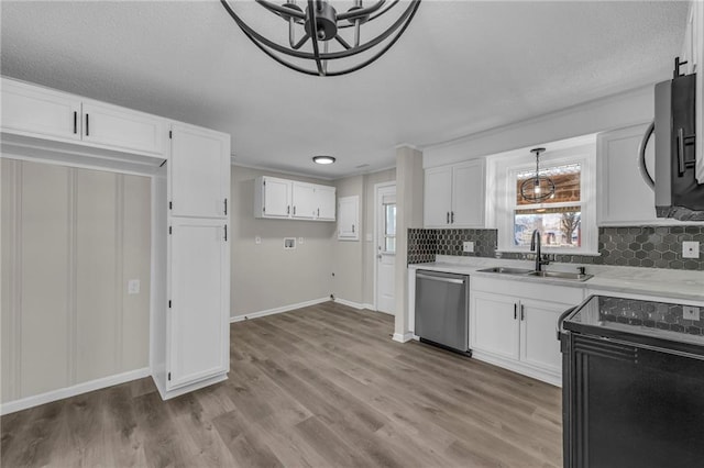 kitchen featuring light countertops, white cabinetry, a sink, black range with electric cooktop, and dishwasher