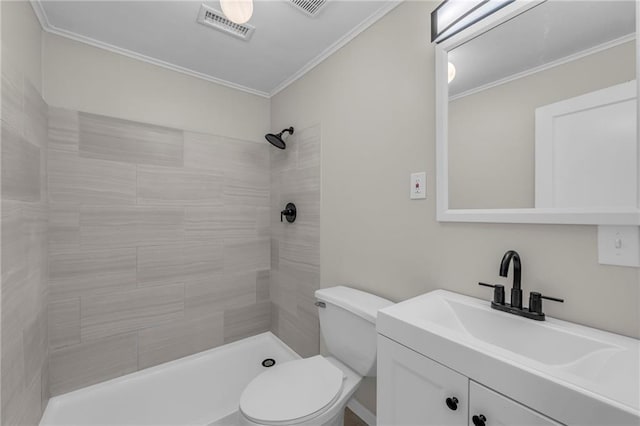 bathroom with visible vents, toilet, a tile shower, crown molding, and vanity