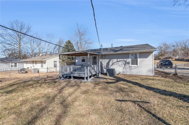 back of property with a yard, fence, and central air condition unit