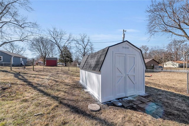 view of shed featuring fence